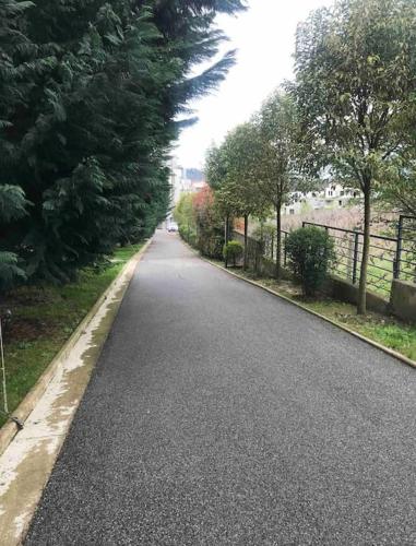 an empty road with trees on the side of it at Spacious apartment in luxury residence in Çeliku