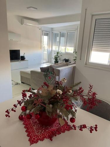a living room with a vase with christmas decorations on a table at Spacious apartment in luxury residence in Çeliku