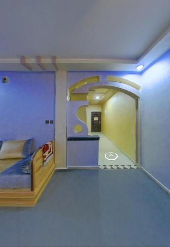 um quarto com uma cama e uma grande janela em شقق فندقية طانطان em Tan-Tan
