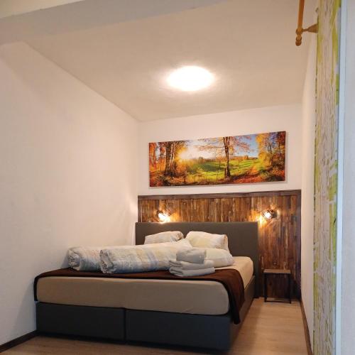 a bedroom with a bed with a painting on the wall at Ferienwohnung Heissl in Fieberbrunn