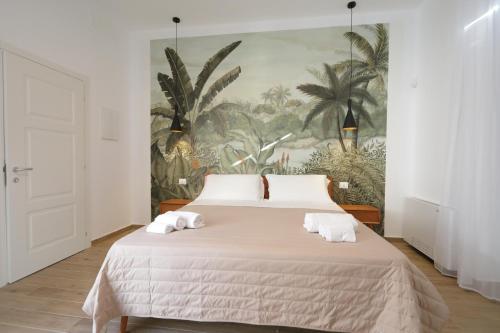 a bedroom with a large bed with towels on it at Il Canto di Ligea in Lamezia Terme