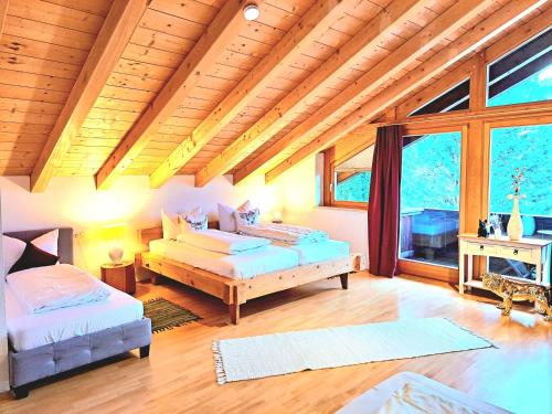 - un salon avec deux lits et une grande fenêtre dans l'établissement Haus Miele, à Garmisch-Partenkirchen