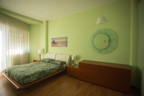 a bedroom with a bed and a mirror on the wall at "Casa incantevole" fronte mare Pescara in Pescara