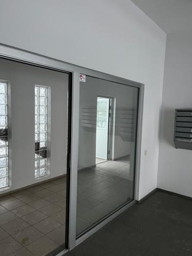a room with sliding glass doors in a building at Cat Garden Elegant Apartments Riga in Rīga
