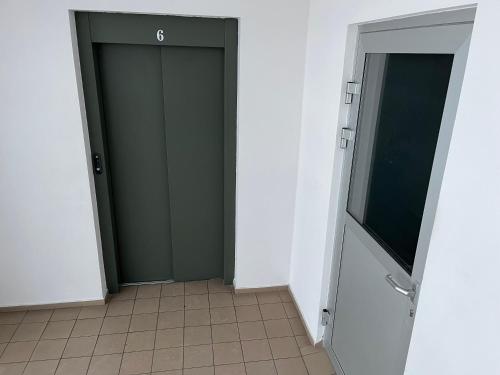a room with two doors and a television in it at Cat Garden Elegant Apartments Riga in Rīga
