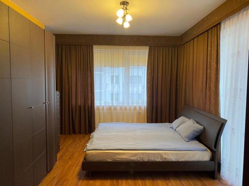a bedroom with a bed and a window at Cat Garden Elegant Apartments Riga in Rīga
