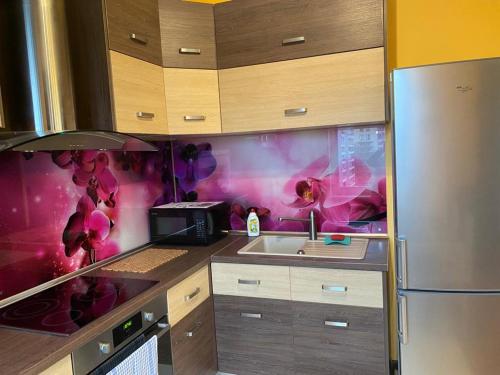 a kitchen with a sink and a refrigerator at Cat Garden Elegant Apartments Riga in Rīga