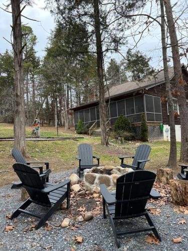 a group of chairs sitting in front of a fire pit at Cozy Cabin w/ Indoor Fireplace & Tranquil views in Luray