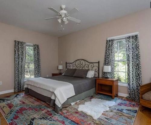 a bedroom with a bed and a ceiling fan at Cozy Cabin w/ Indoor Fireplace & Tranquil views in Luray