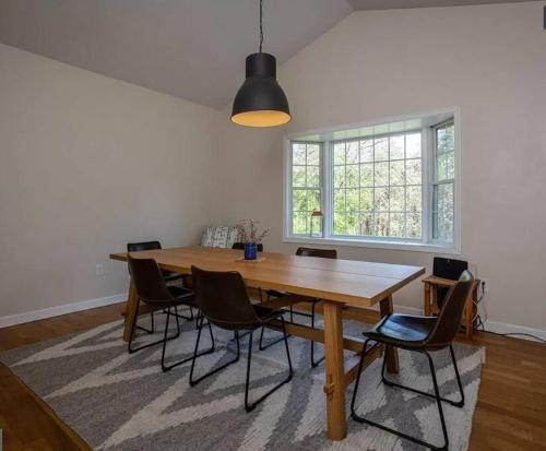 a dining room with a wooden table and chairs at Cozy Cabin w/ Indoor Fireplace & Tranquil views in Luray