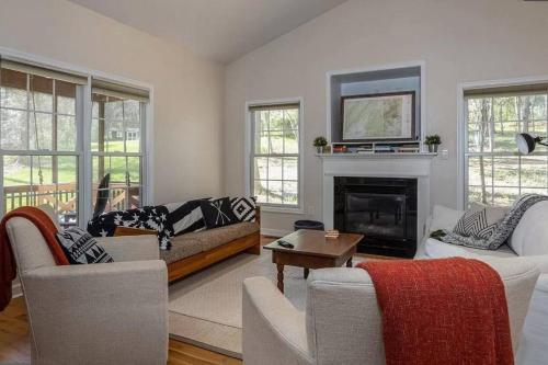 a living room with a couch and a fireplace at Cozy Cabin w/ Indoor Fireplace & Tranquil views in Luray