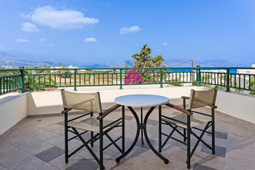 a table and two chairs on a balcony at Hydramis Palace Beach Resort in Georgioupolis