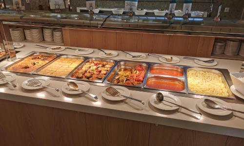 a buffet line with many different types of food at Hydramis Palace Beach Resort in Georgioupolis