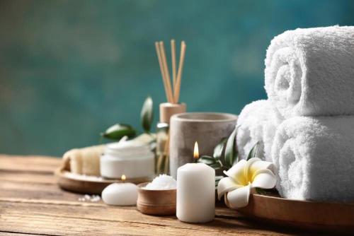 a group of towels and candles on a table at Hydramis Palace Beach Resort in Georgioupolis