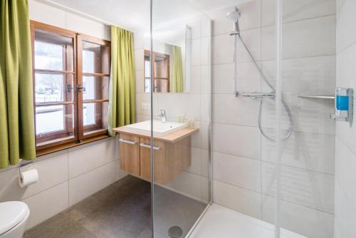 a bathroom with a shower and a sink at Hotel Sonne in Brand