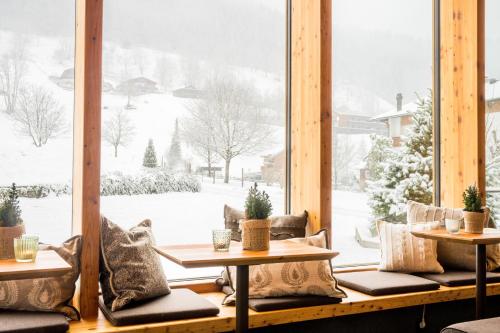 a room with a large window with snow outside at Hotel Sonne in Brand