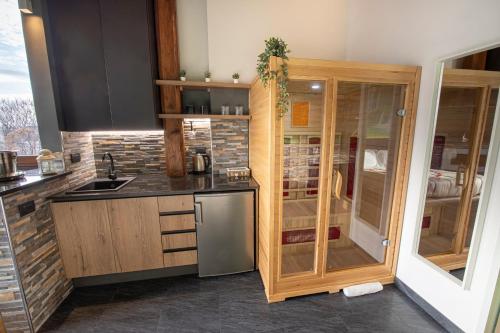 a kitchen with wooden cabinets and a stainless steel refrigerator at Virtus Prestige - Rooms & Apartments in Rome