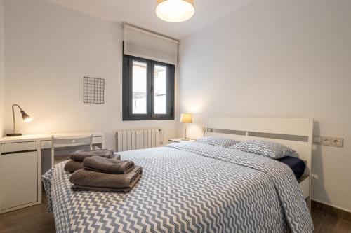 a bedroom with a bed with towels on it at RentitSpain Centro de Granada cerca de la Catedral in Granada