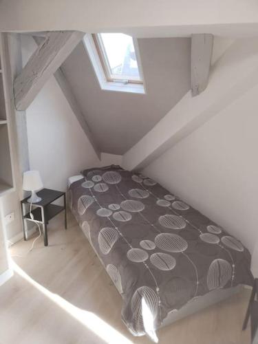 een slaapkamer met een bed op zolder bij Charmant appartement cosy in Sélestat
