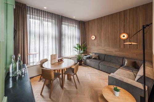 a living room with a table and a couch at Hotel Arena in Amsterdam