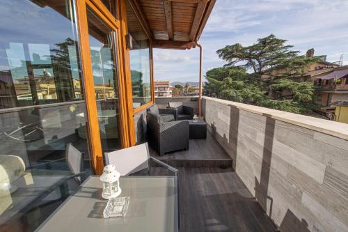 a balcony with a table and chairs on a building at Virtus Prestige - Rooms & Apartments in Rome