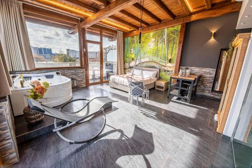 a bathroom with a tub and a table and a couch at Virtus Prestige - Rooms & Apartments in Rome