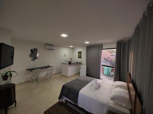 Ένα ή περισσότερα κρεβάτια σε δωμάτιο στο Flats Paraíso Louveny