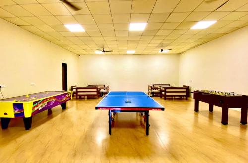 a room with two ping pong tables in it at Jagira Ananta Elite , Sasan Gir in Chitrod
