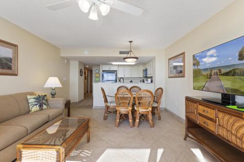 a living room with a couch and a table and chairs at Sunny and Bright Oceanfront Condo in Atlantica Resort near Boardwalk in Myrtle Beach