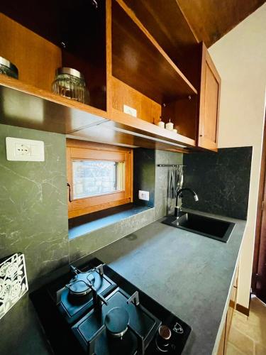 a kitchen with a stove and a sink in it at Agriturismo Casale Montebello in Monteleone di Spoleto