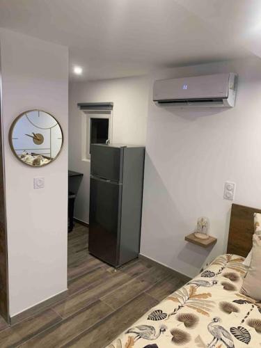 Cette chambre comprend un réfrigérateur et un lit. dans l'établissement Cosy jacuzzi, à Orange