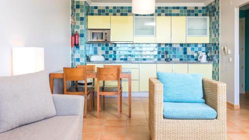 a kitchen with a table and chairs in a room at Alfagar Alto da Colina in Albufeira