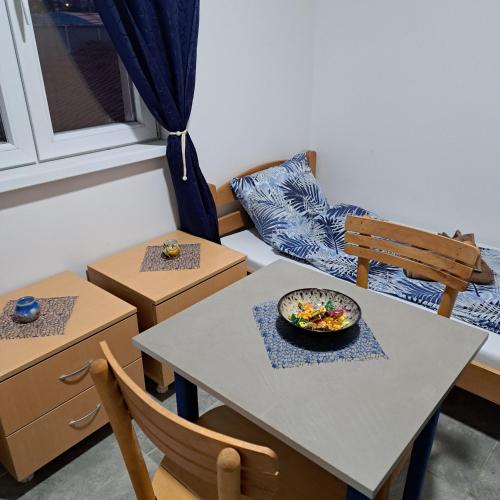a dining room with a table and two chairs at LIBERO APARTMANI in Surčin