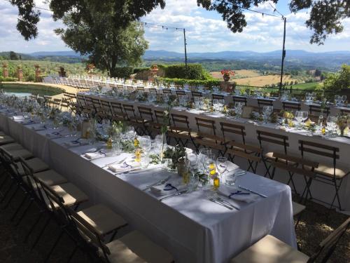 a long table set up for a wedding with a view at Fattoria di Cinciano in Poggibonsi