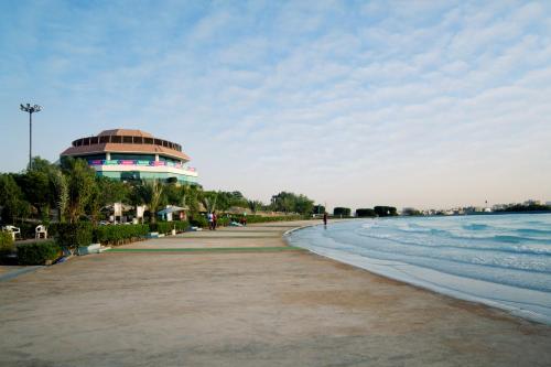 a building on the beach next to the water at Dreamworld Resort, Hotel & Golf Course in Karachi