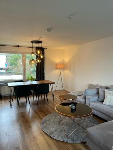 a living room with a couch and a table at Wohlfühlapartment Braunschweig in Bergisch Gladbach