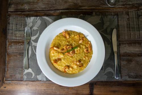 a white plate with a bowl of food on a table at Interclass Florianópolis in Florianópolis