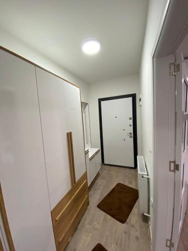 a room with a hallway with a door and a mirror at White Apartments in Kosovo Polje
