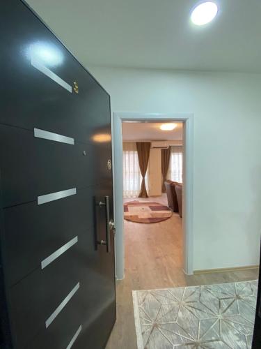 a door leading into a room with a living room at White Apartments in Kosovo Polje