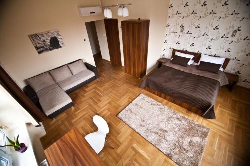 a living room with two beds and a couch at SasOne Rooms in Budapest