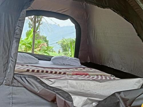 a bed in the inside of a tent at Freedom Camp Ella in Ella