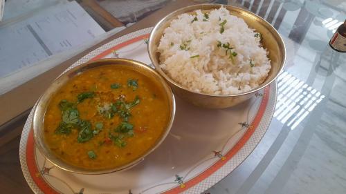 two bowls of food on a plate with rice at KANAK HOME STAY in Varanasi