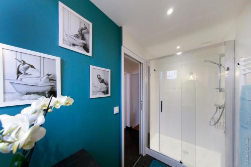 uma casa de banho com um chuveiro e uma parede azul em Maison « De Ville en Vigne » em Chenôve