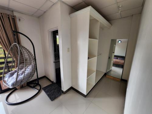 a room with a chair and shelves in it at Baguio Hillside Haven in Baguio