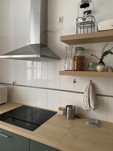 a kitchen with a counter with a stove top oven at GALLE - Apartamento dos Infantes in Beja