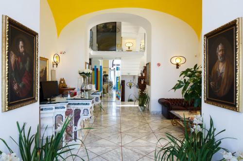 a living room with paintings on the walls at Antico Casale Russo in Piano di Sorrento