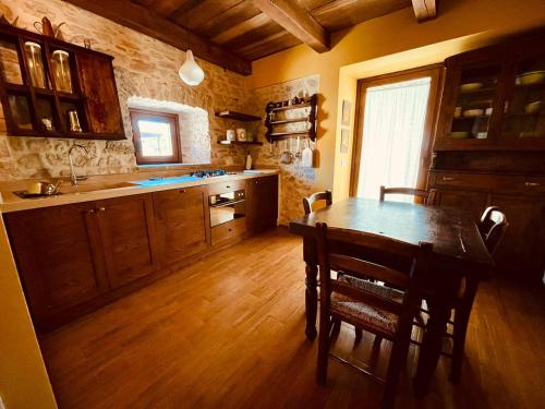 a kitchen with a table and chairs in a room at Agriturismo Casale Montebello in Monteleone di Spoleto