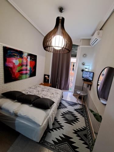 a bedroom with a bed and a pendant light at Calle Mayor next to beach in Alicante