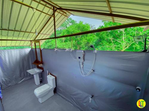 a bathroom with a shower and a toilet in a tent at mango villa wilpattu in Nekattegama