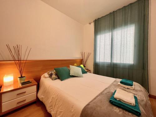 a bedroom with a large bed and a window at Prop de mar a 60m de la playa in Calafell